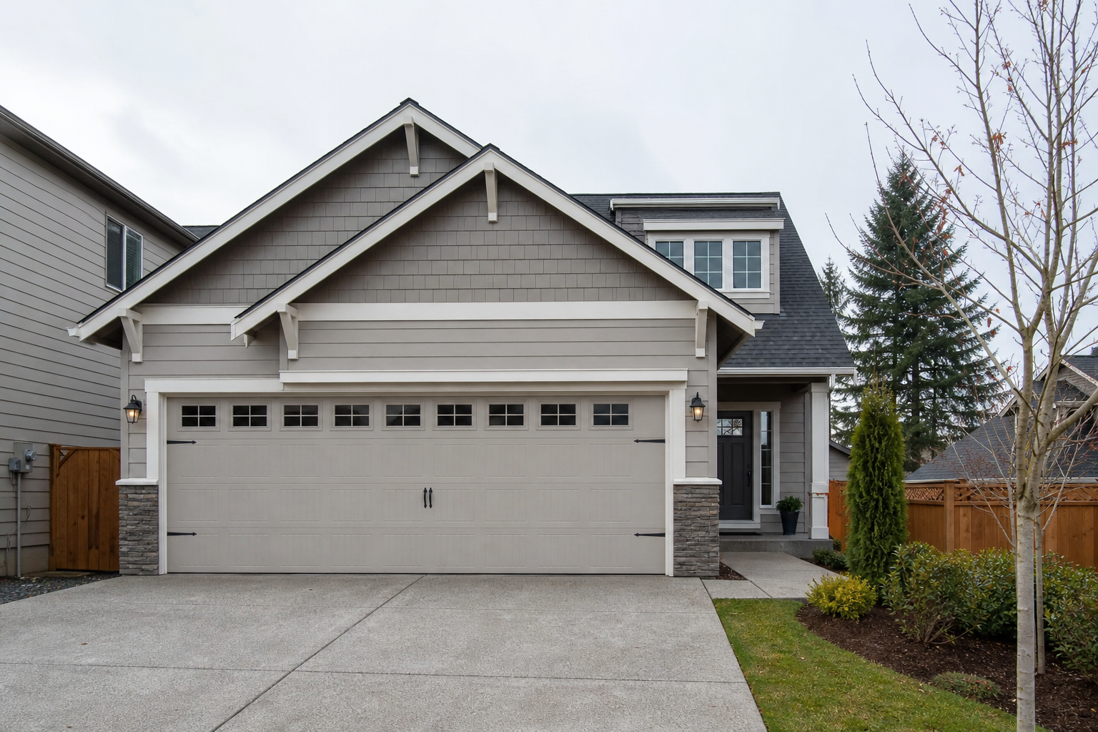 Suburban Vancouver, WA home with a closed garage door on an overcast day
